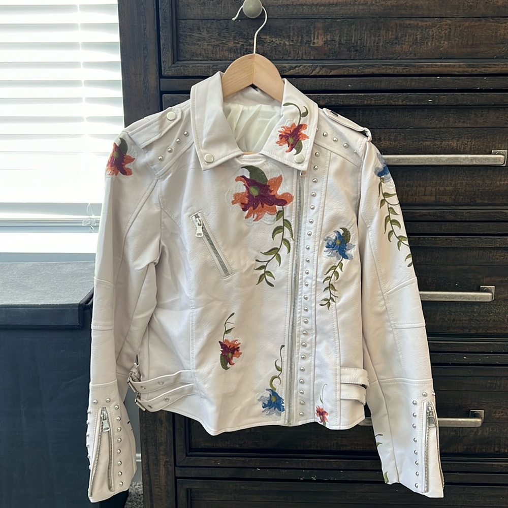 Embroidered faux leather jacket. Ivory with silver accents, zipper, and studs
